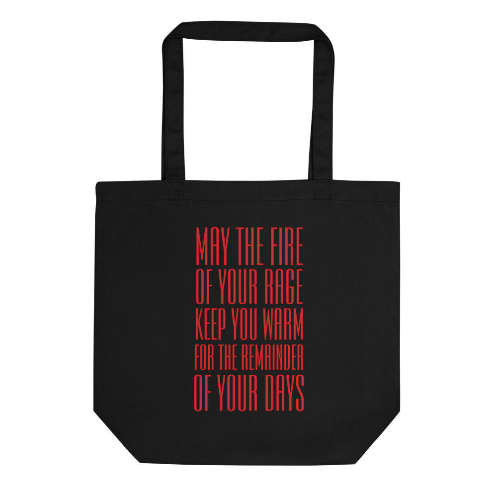 Black tote bag that reads MAY THE FIRE OF YOUR RAGE KEEP YOU WARM FOR THE REMAINDER OF YOUR DAYS in bold red text, on a white background 